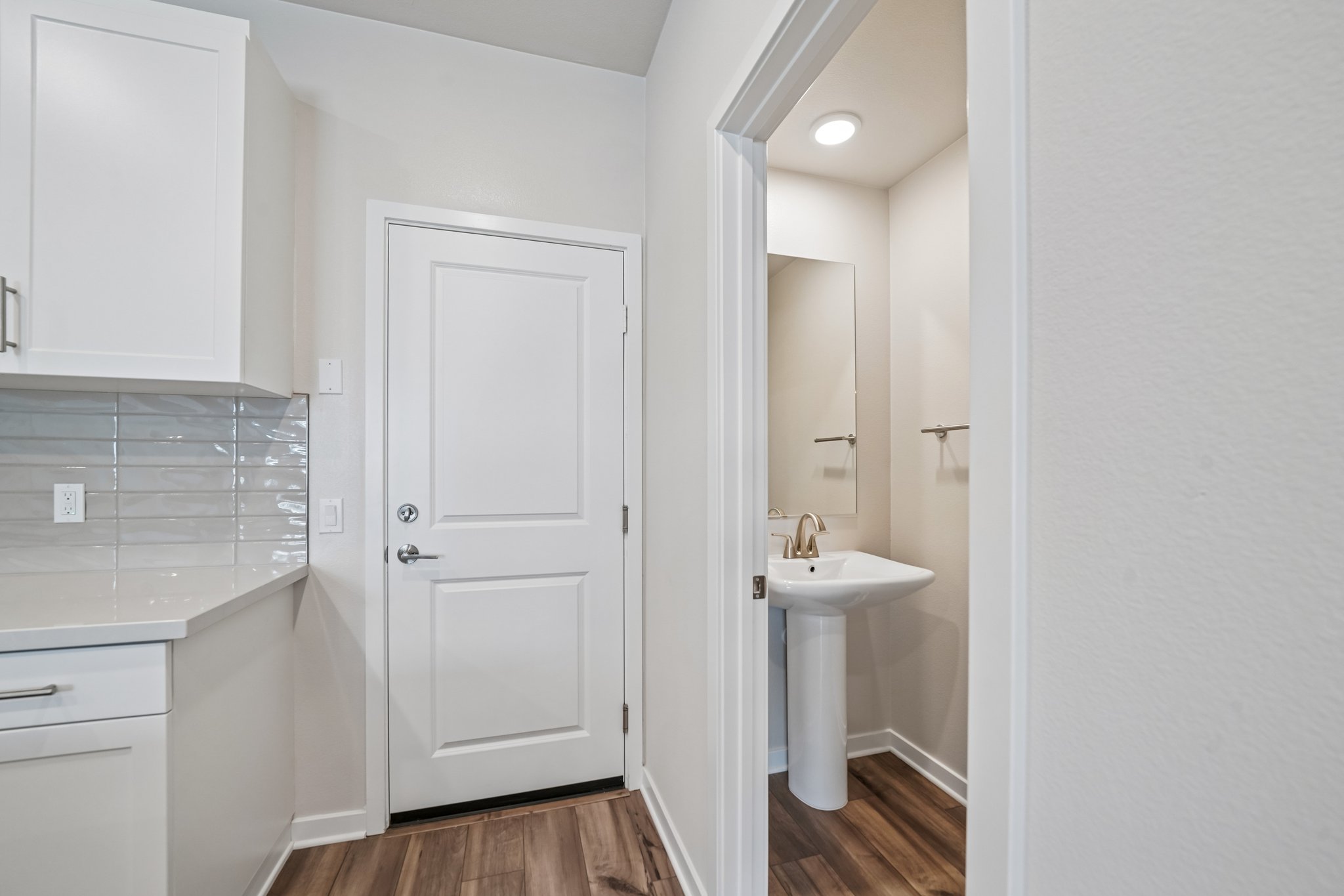 A bathroom with white cabinets.