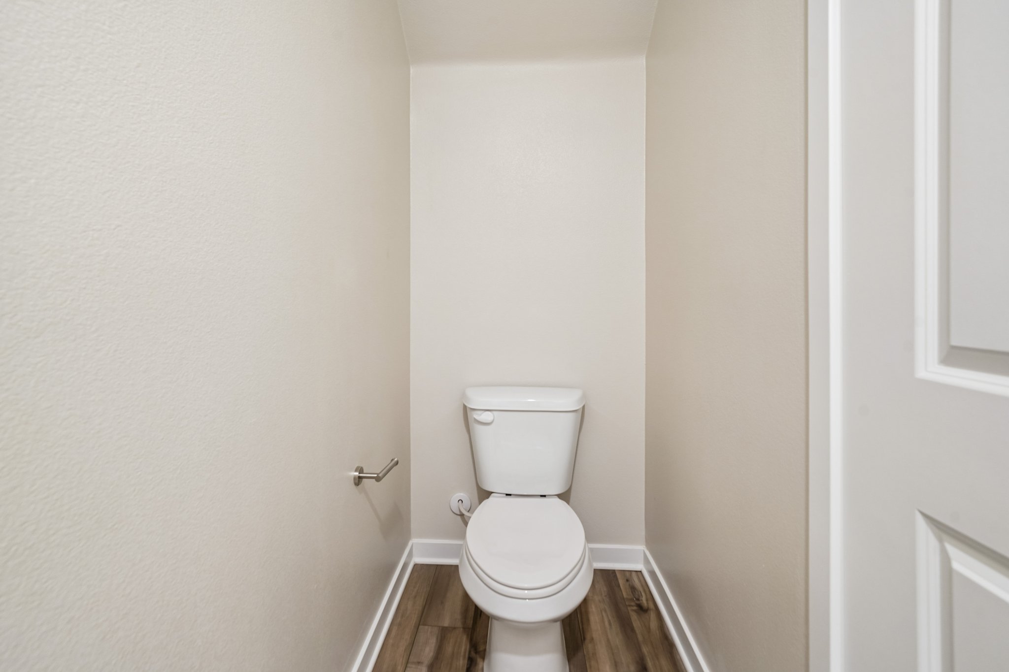 A toilet in a bathroom.
