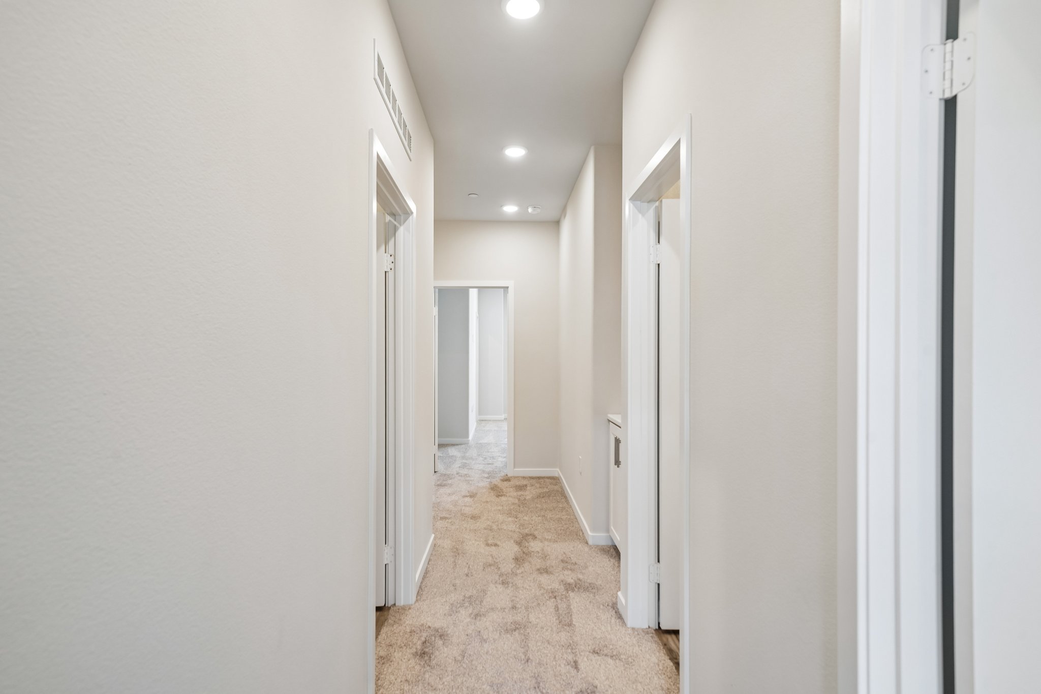A hallway with white walls.