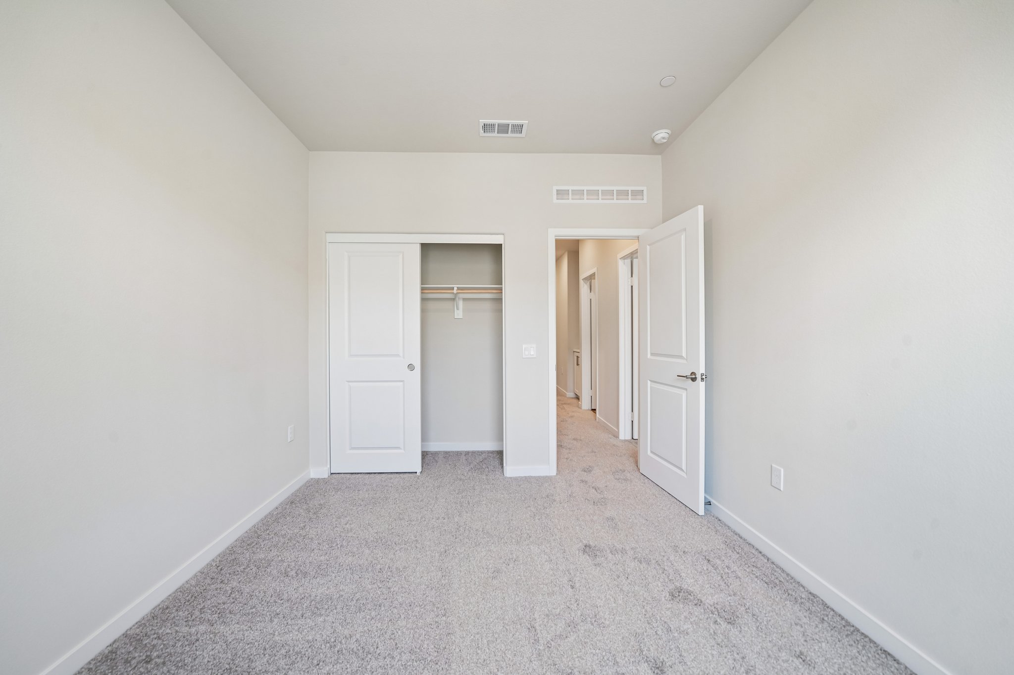 A hallway with white doors.