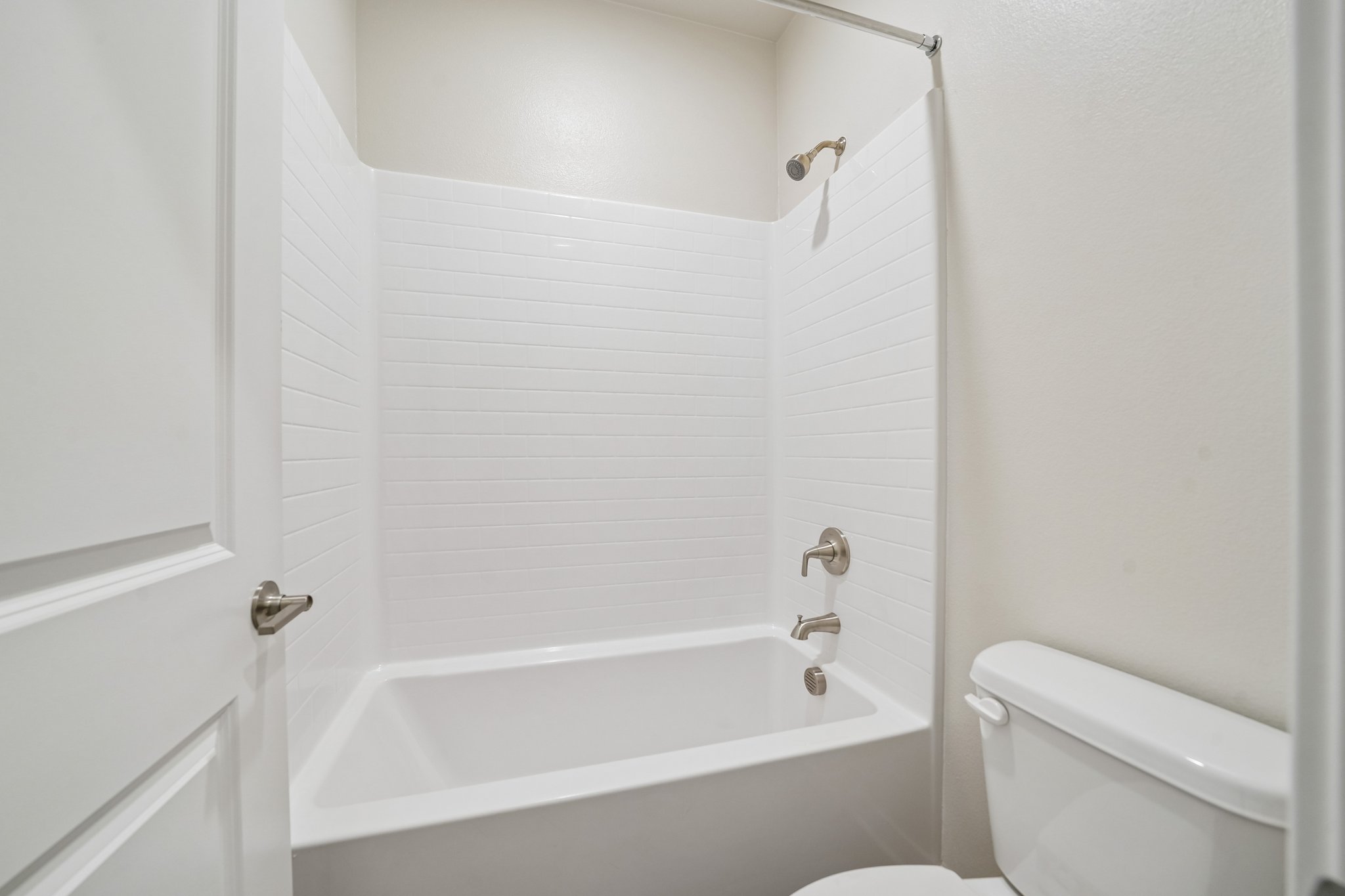A bathroom with a bathtub toilet and sink.