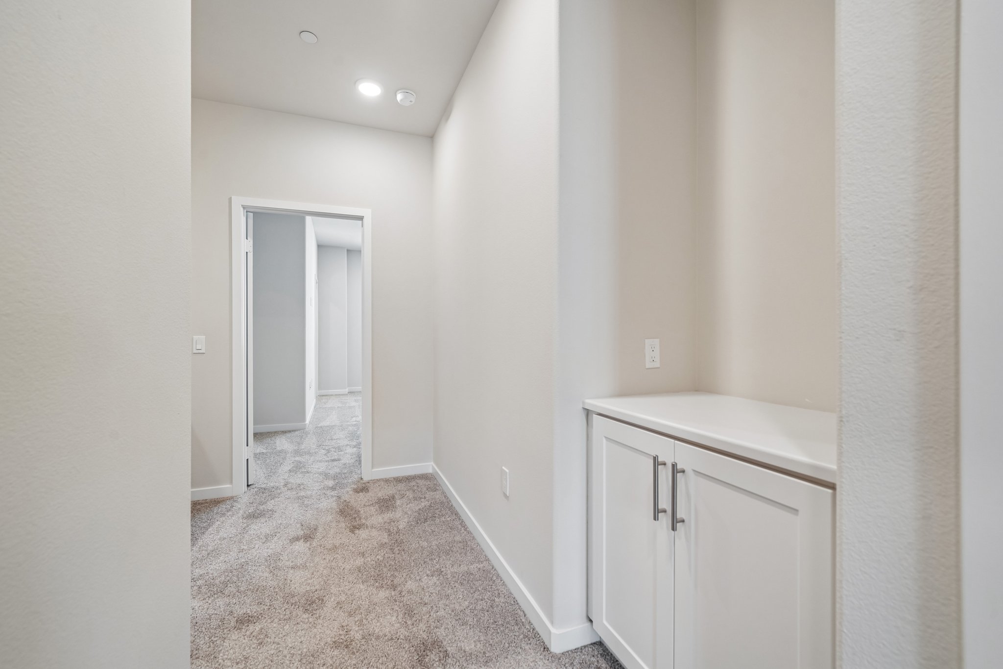 A hallway with white walls.