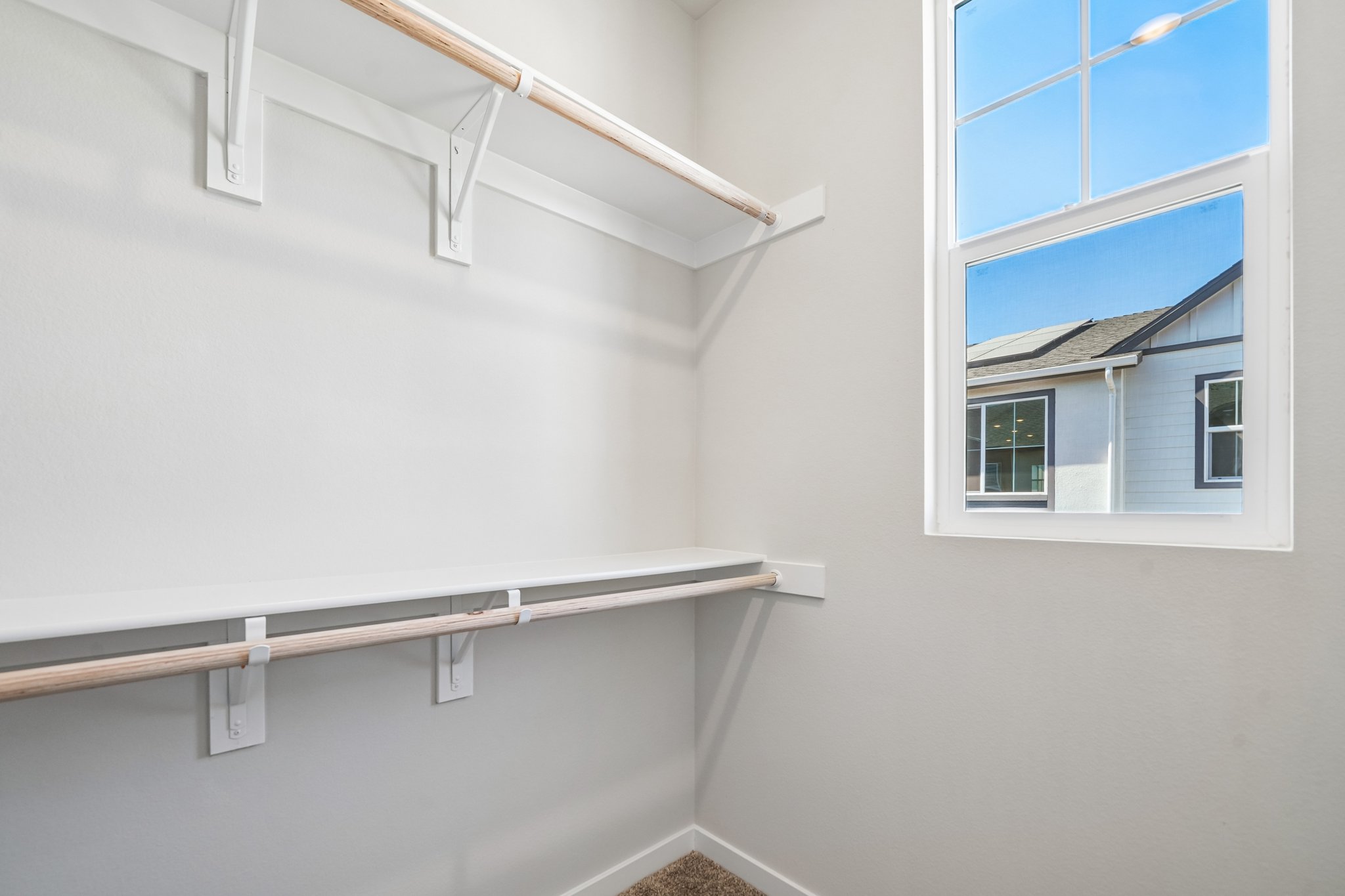 A white room with a window and a white wall.