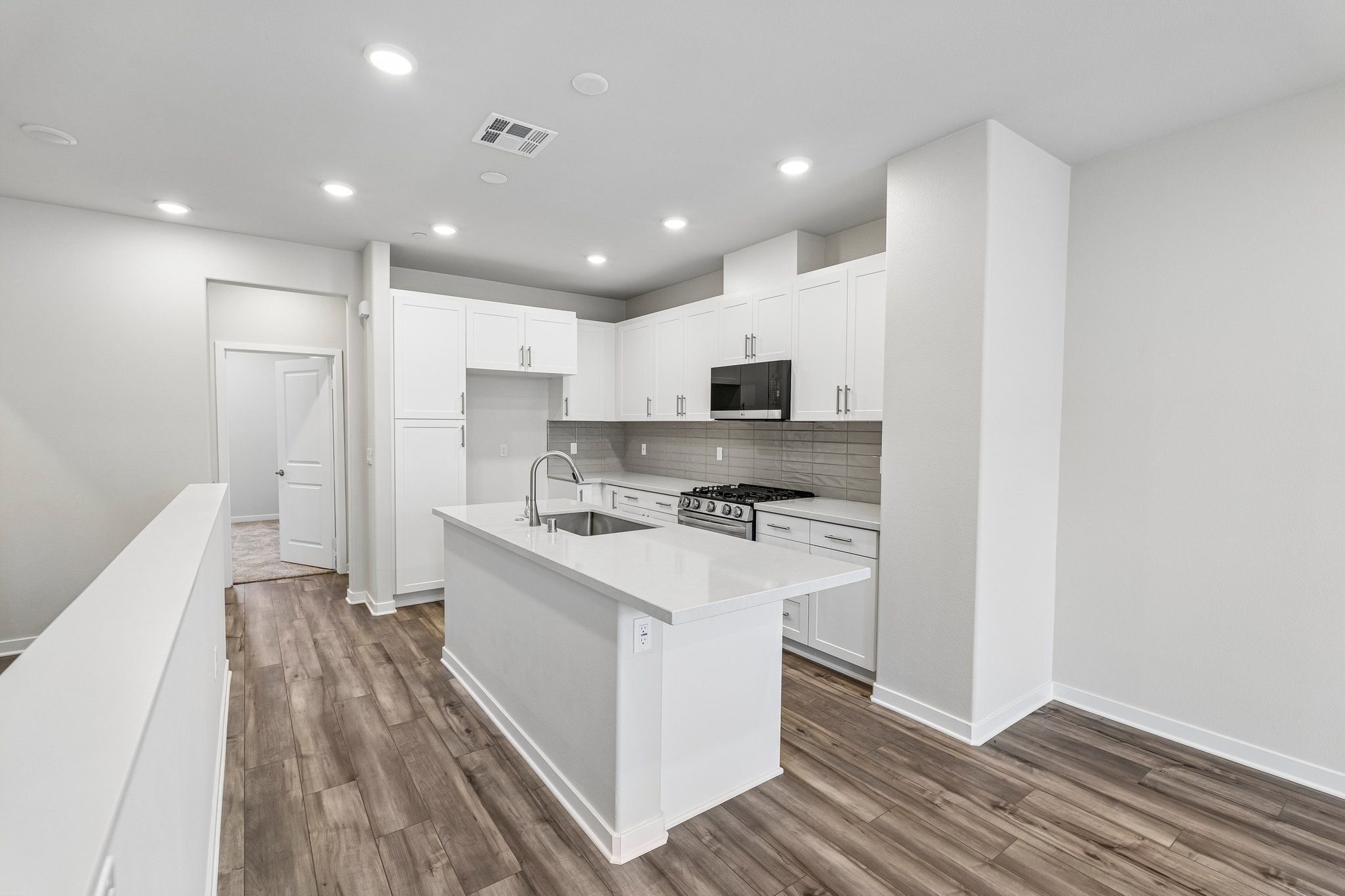 A kitchen with white cabinets.