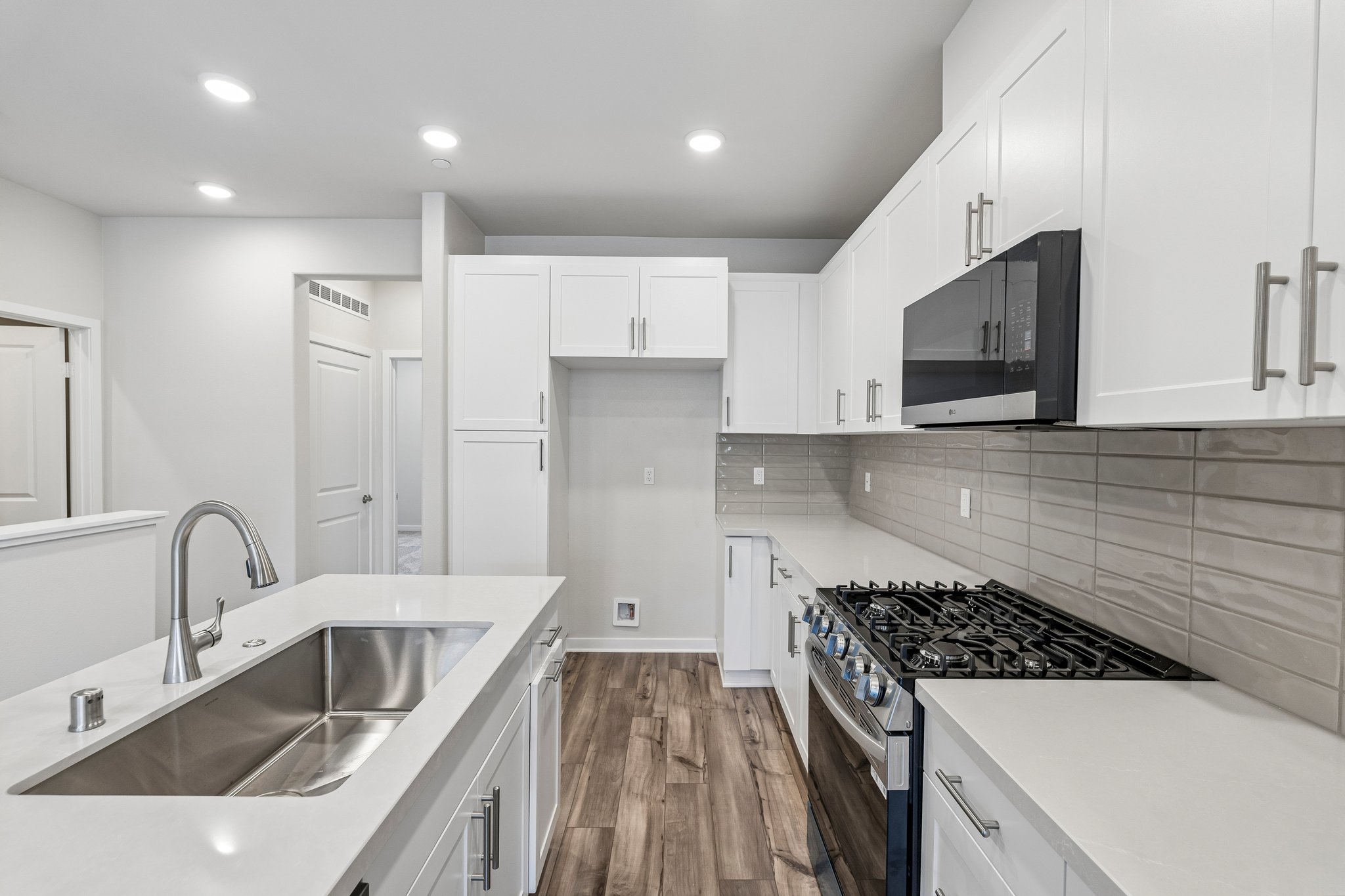 A kitchen with white cabinets.