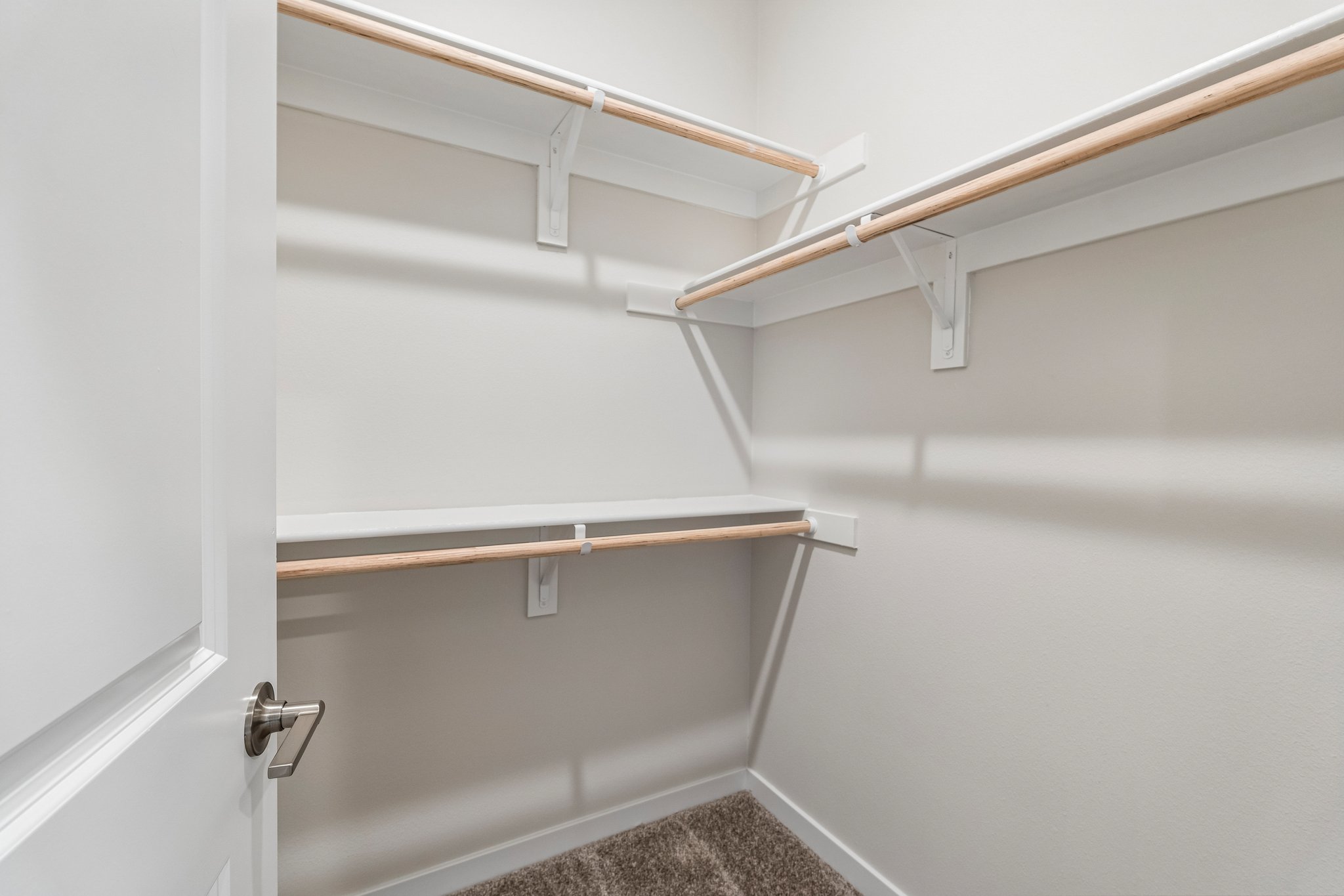 A white wall with a metal bar.