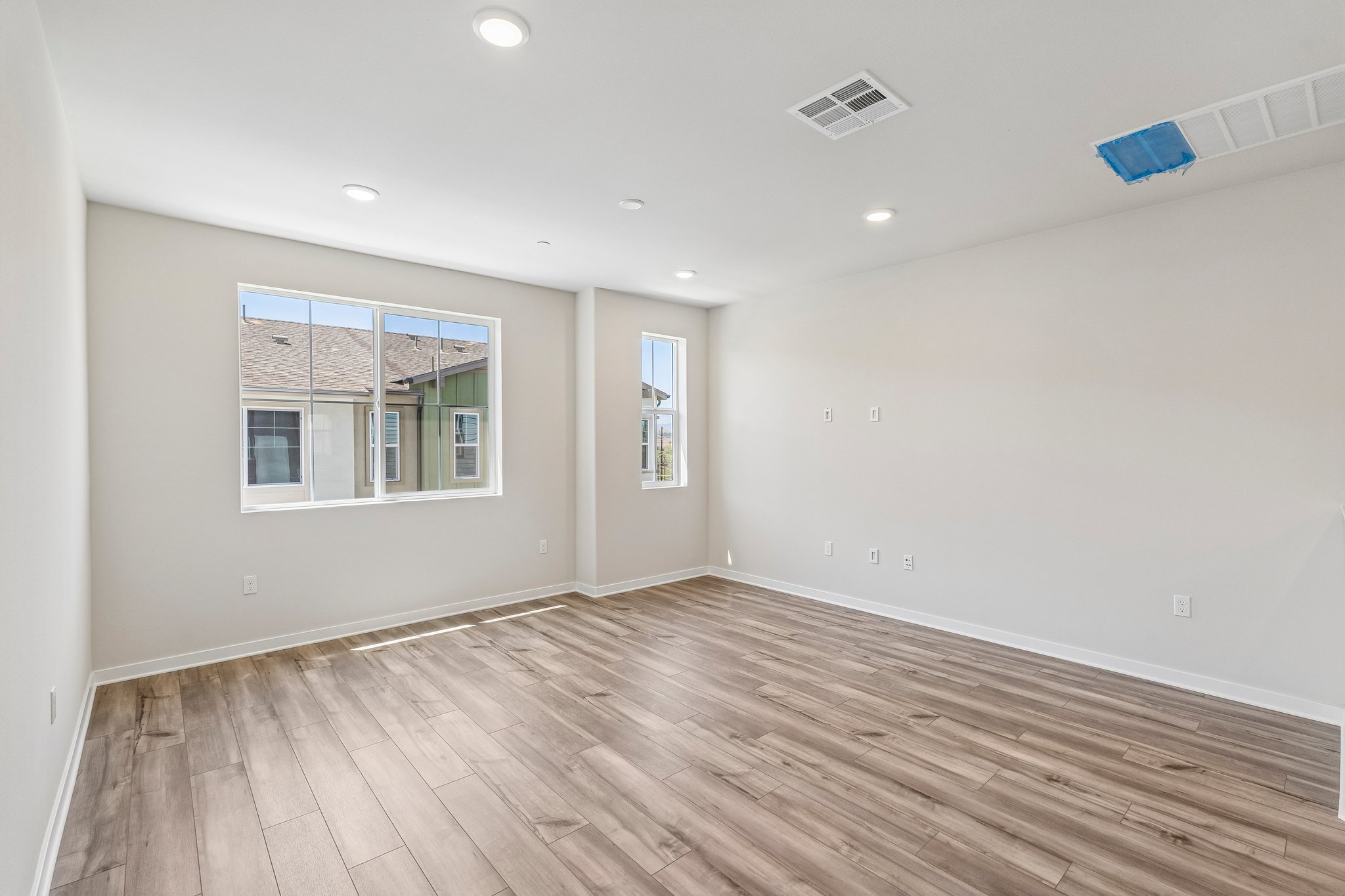 A room with a wood floor and a window.