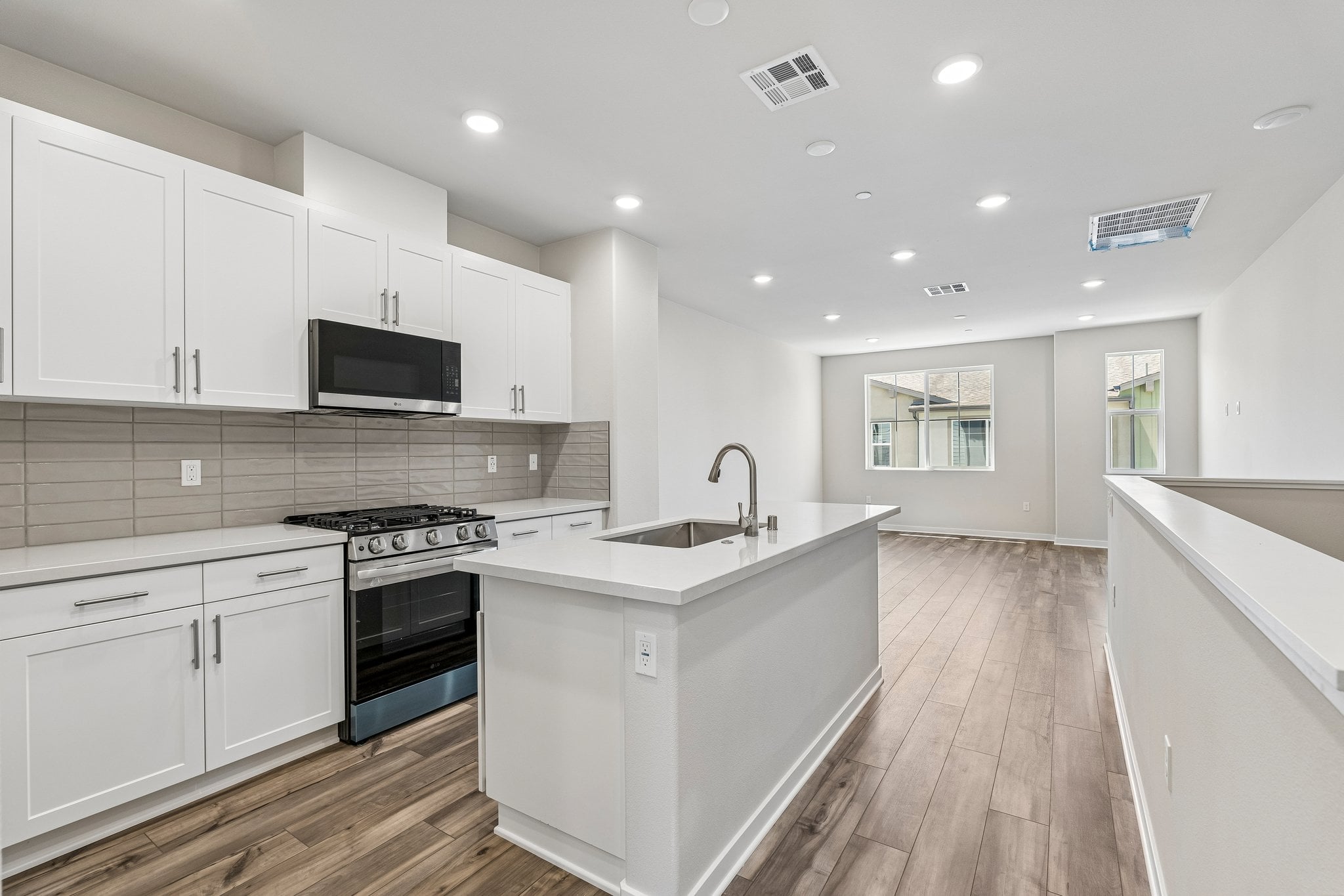 A kitchen with white cabinets.