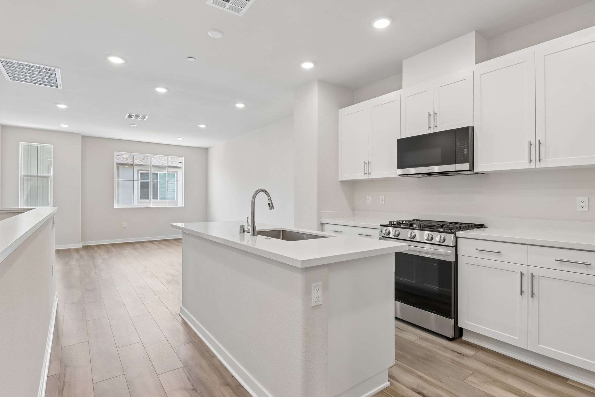 A kitchen with white cabinets.