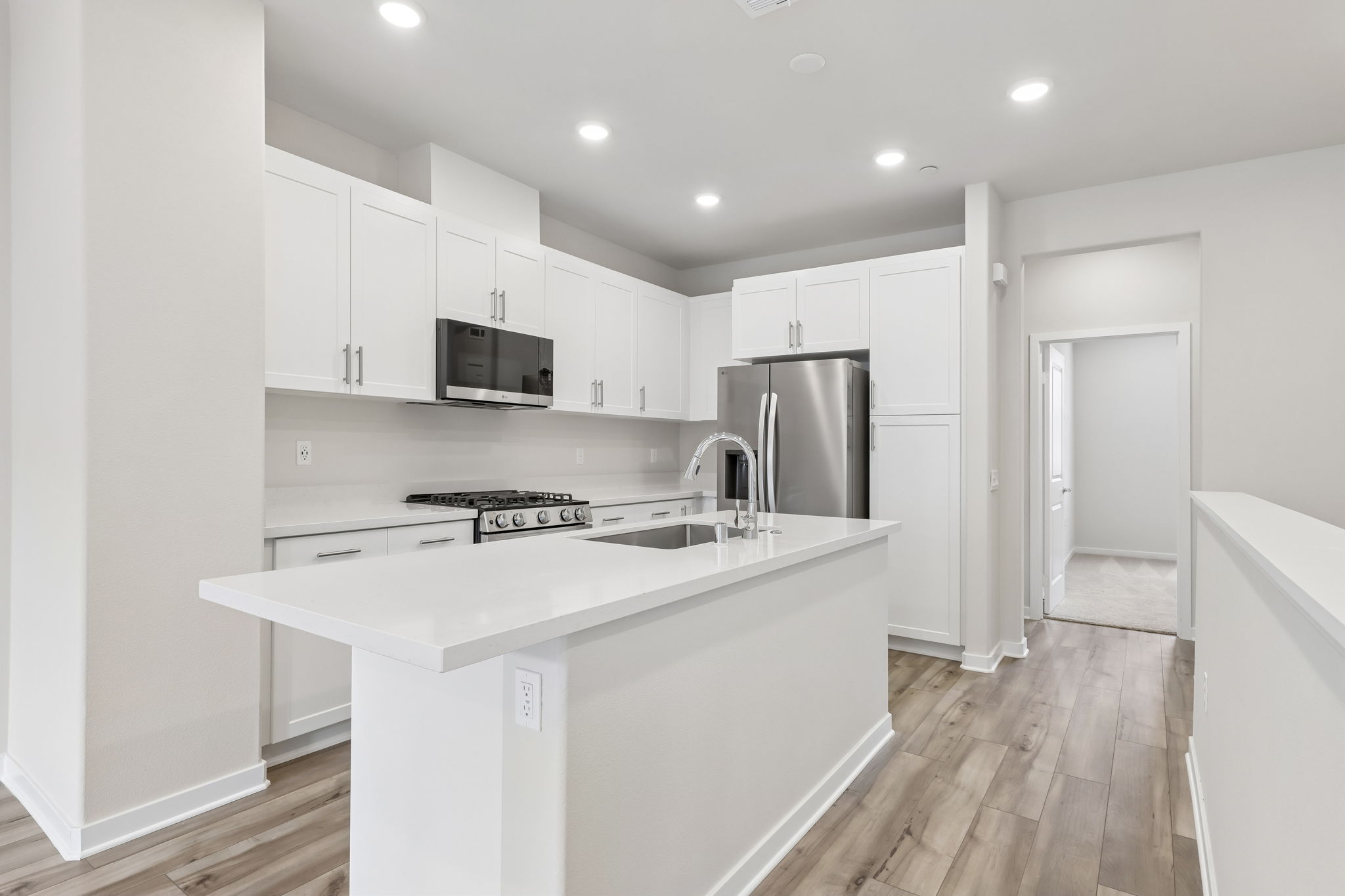 A kitchen with white cabinets.