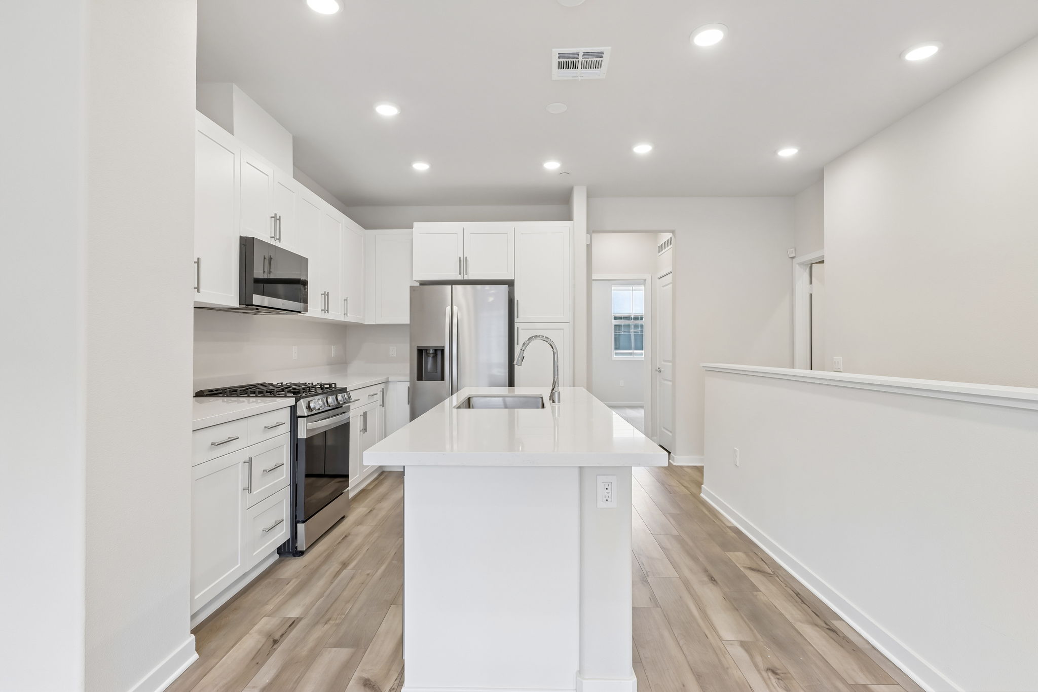 A kitchen with white cabinets.