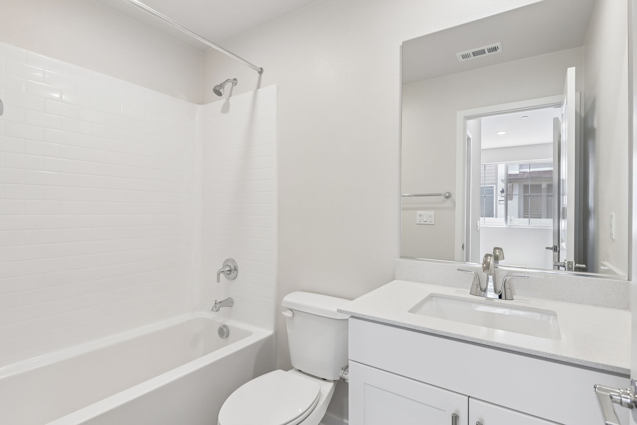 A bathroom with a tub sink and toilet.