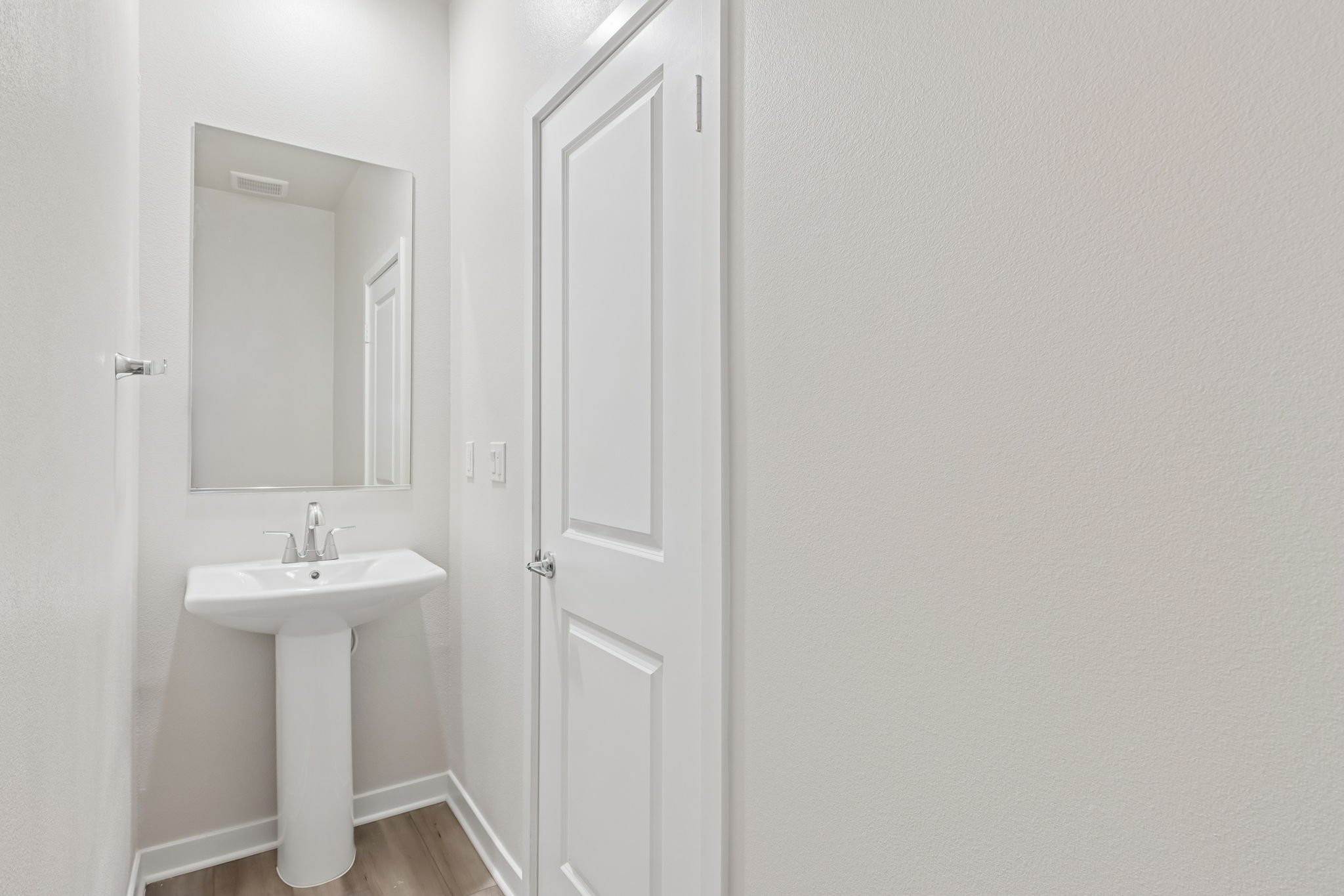 A bathroom with a sink and a mirror.
