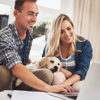 couple on laptop with puppy