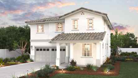 A white house with a green lawn.