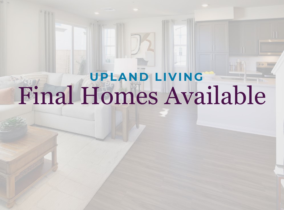 A room with white couches and a table.