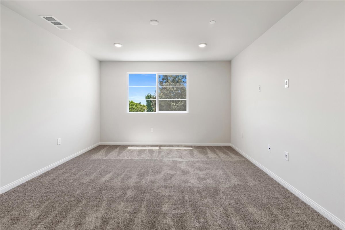 A room with a window and a rug.