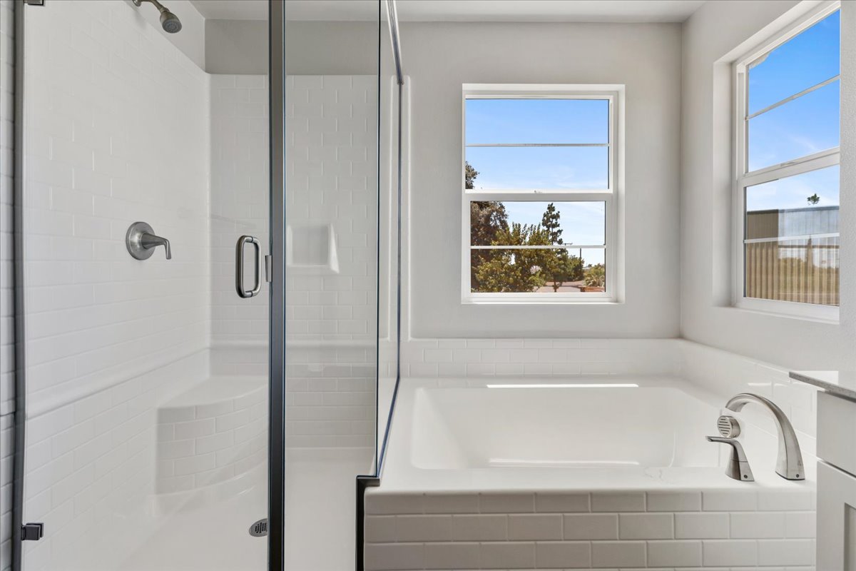 A bathroom with a tub and windows.