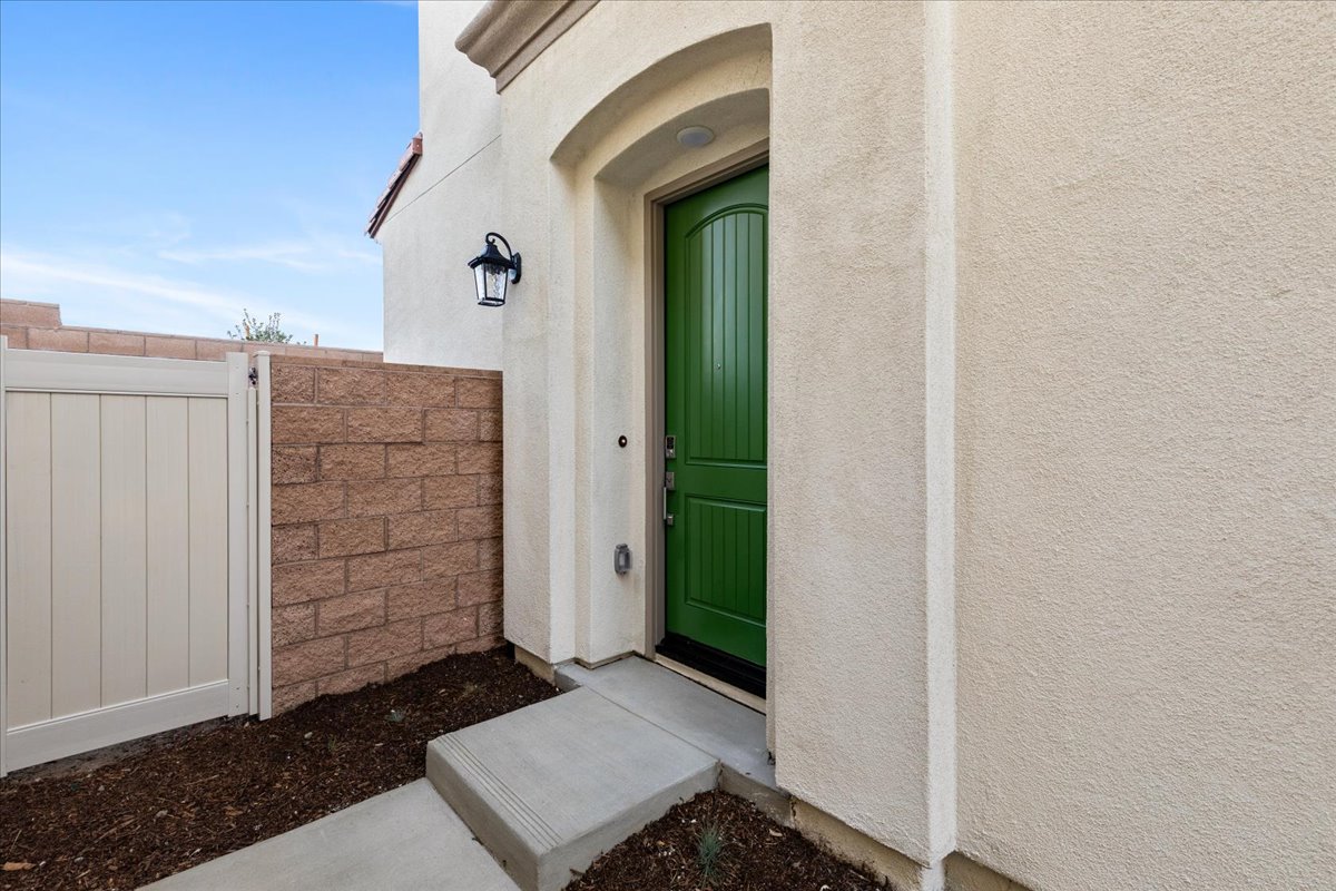 A white building with a green door.