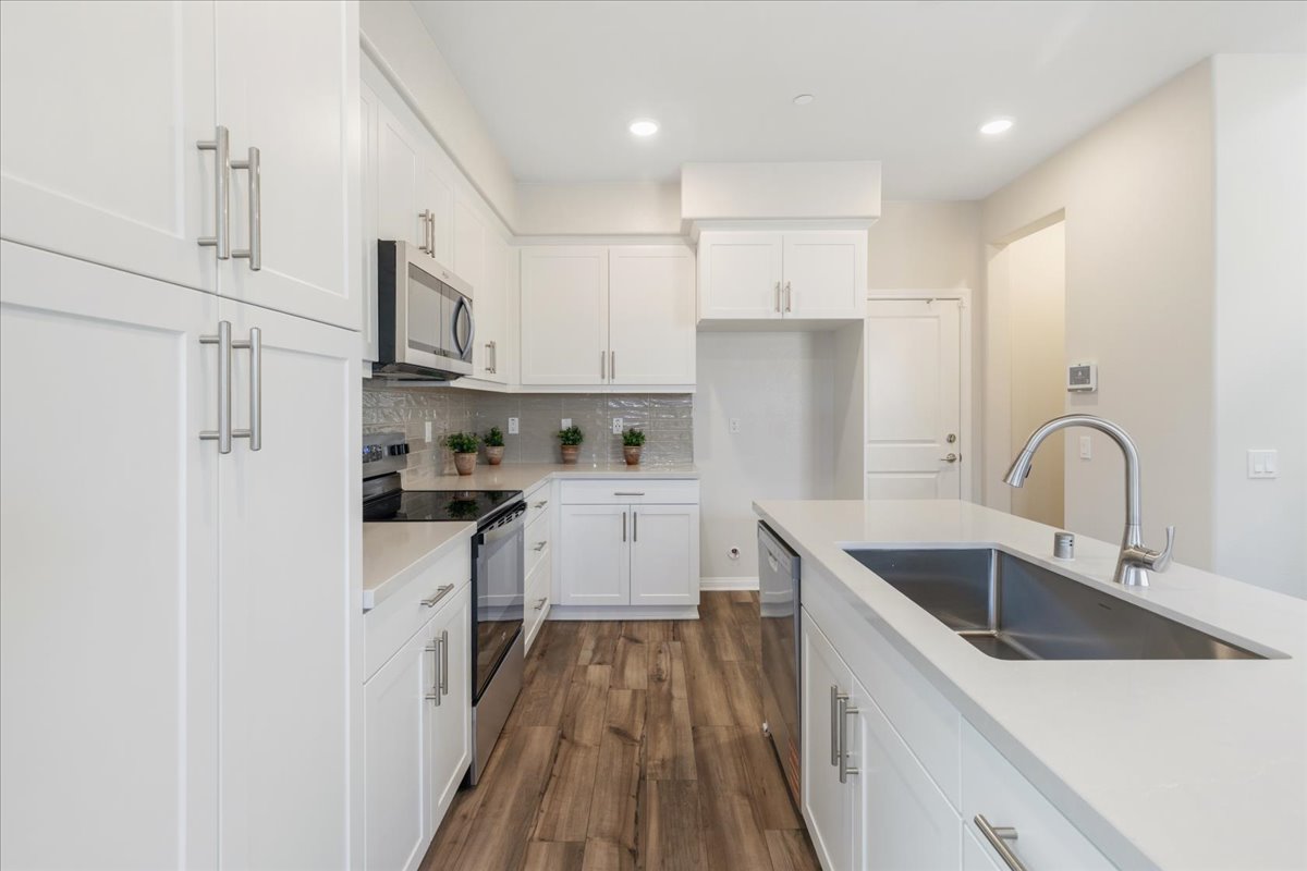 A kitchen with white cabinets.