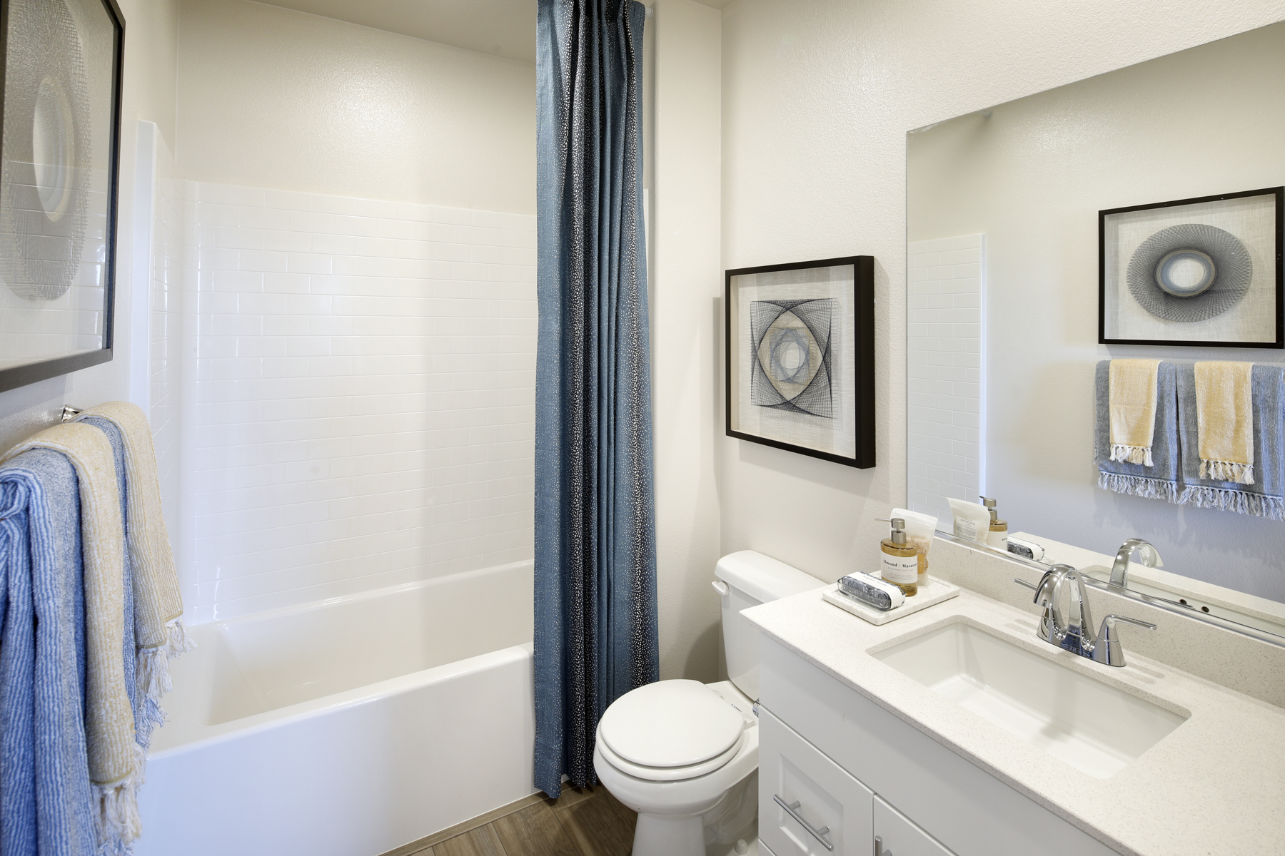 A bathroom with a sink toilet and bathtub.