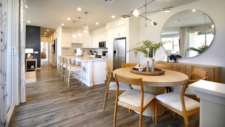 A large kitchen with a dining table.