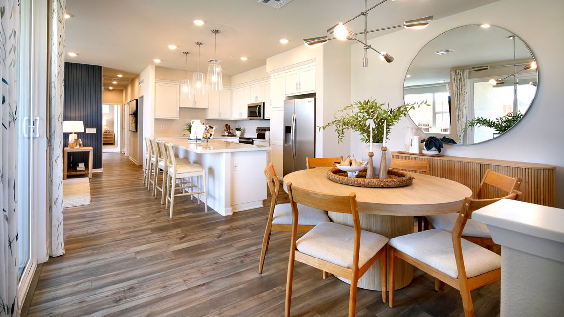 A large kitchen with a dining table.