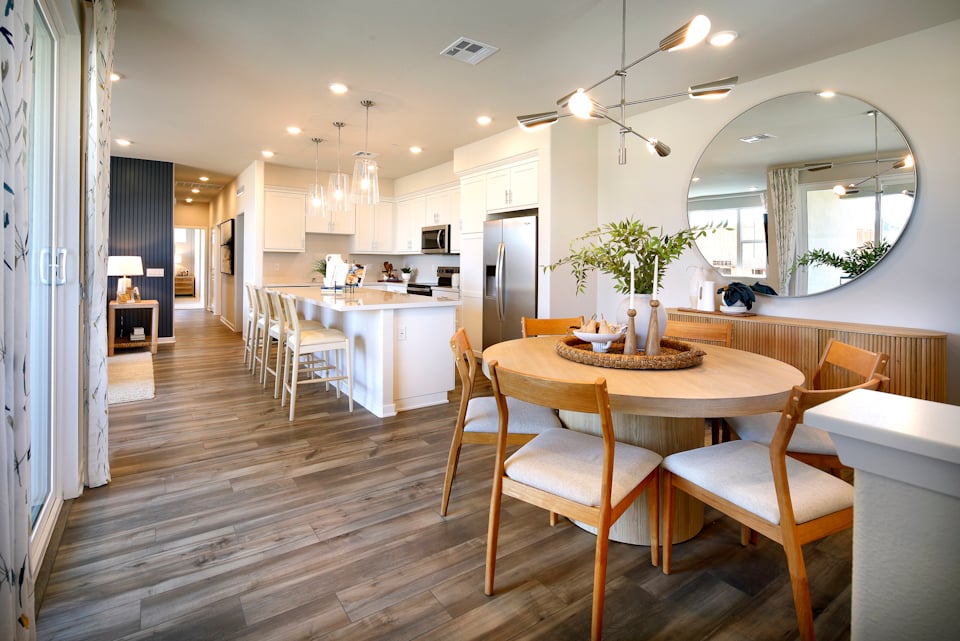 A large kitchen with a dining table.
