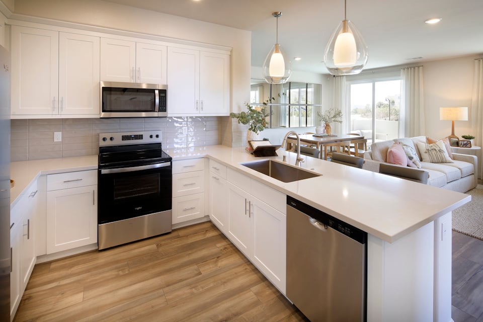A kitchen with white cabinets.