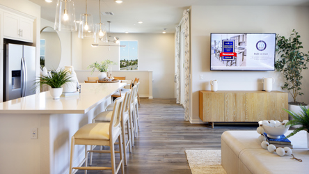 A kitchen with a bar and a tv.