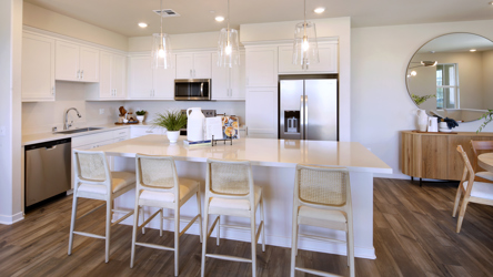 A kitchen with white cabinets.