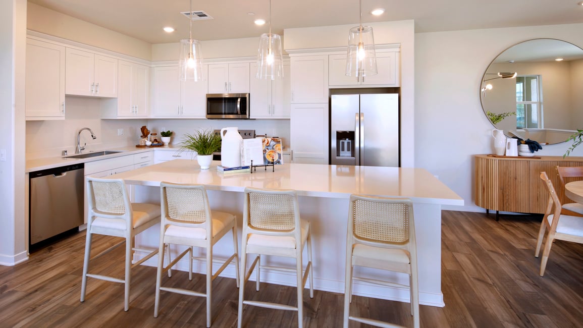 A kitchen with white cabinets.