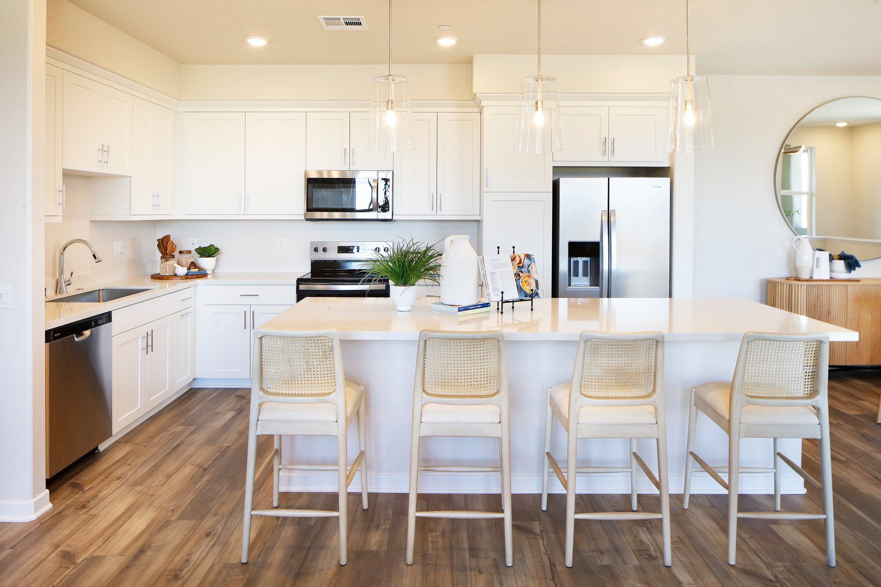 A kitchen with white cabinets.