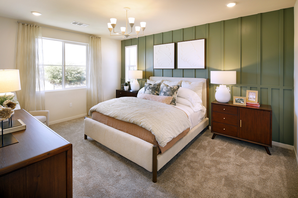 A bedroom with a bed and a desk.