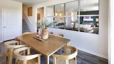 A dining room table with chairs.