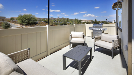 A deck with chairs and a table.