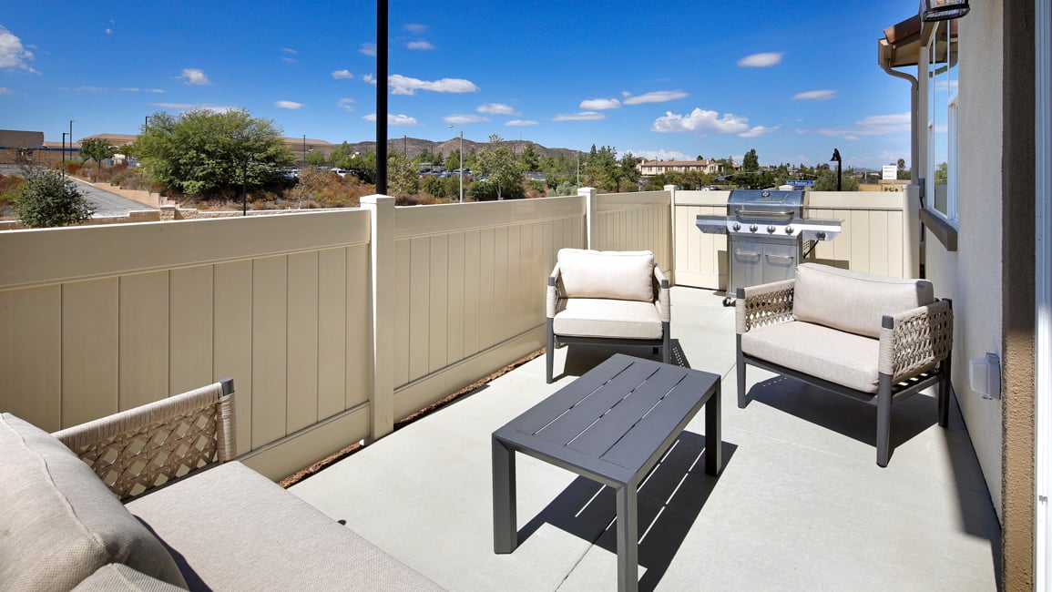 A deck with chairs and a table.