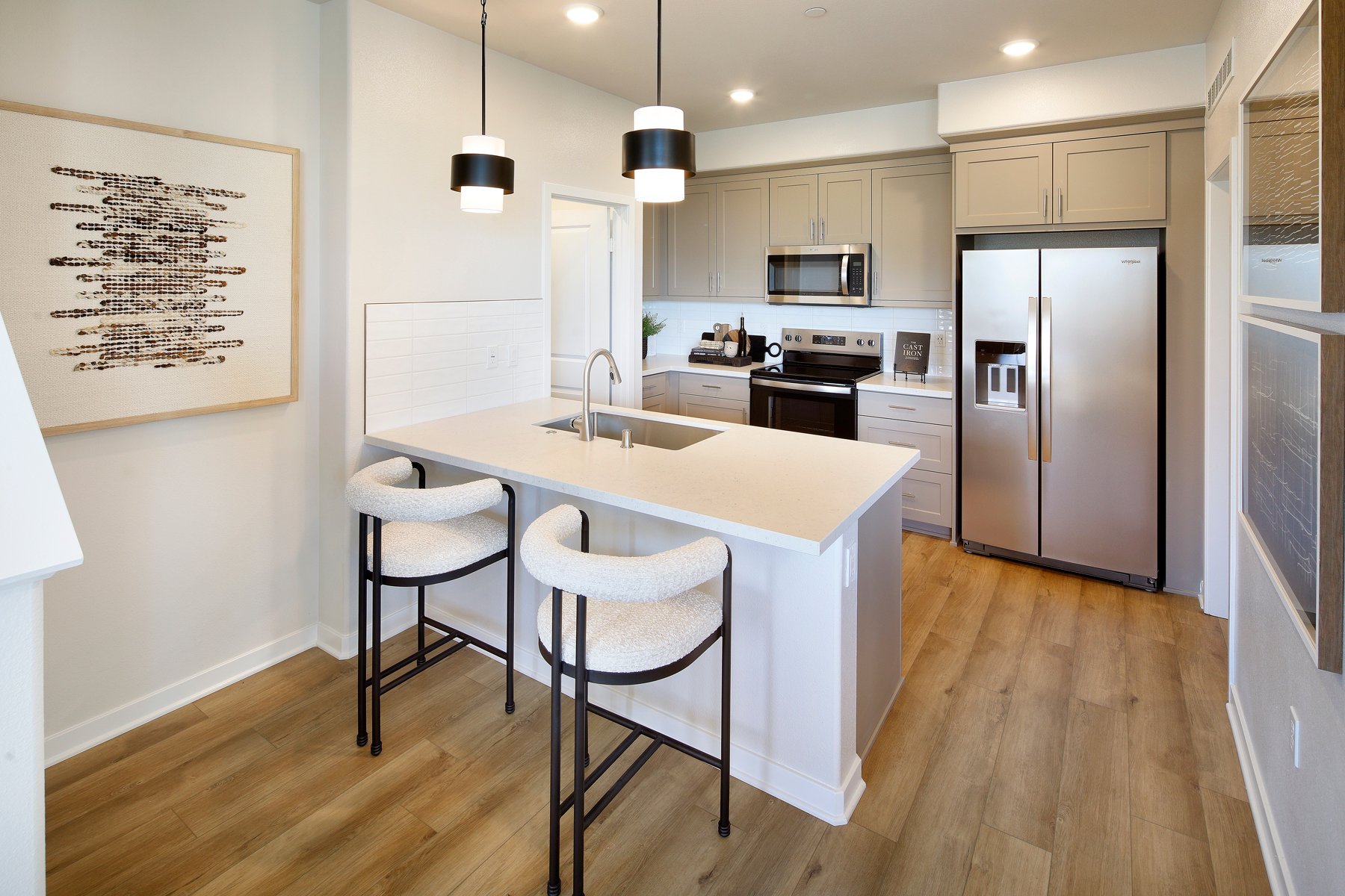 A kitchen with a table and chairs.