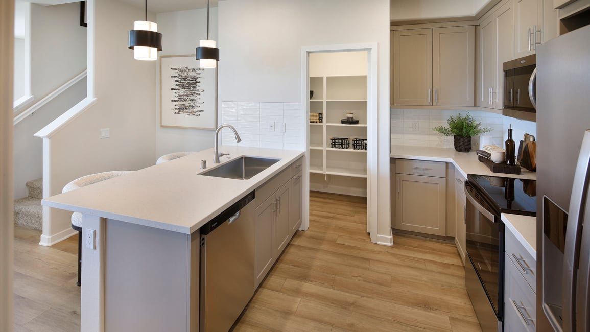 A kitchen with white cabinets.