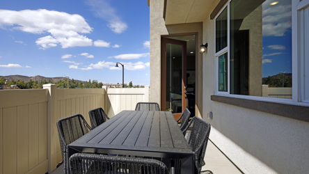 A table and chairs on a deck.