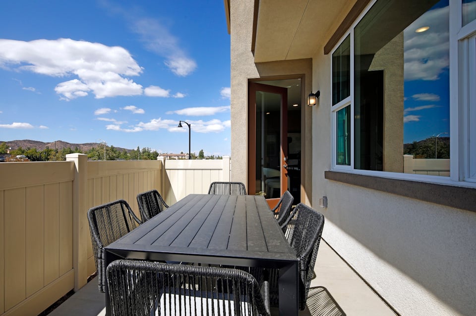 A table and chairs on a deck.