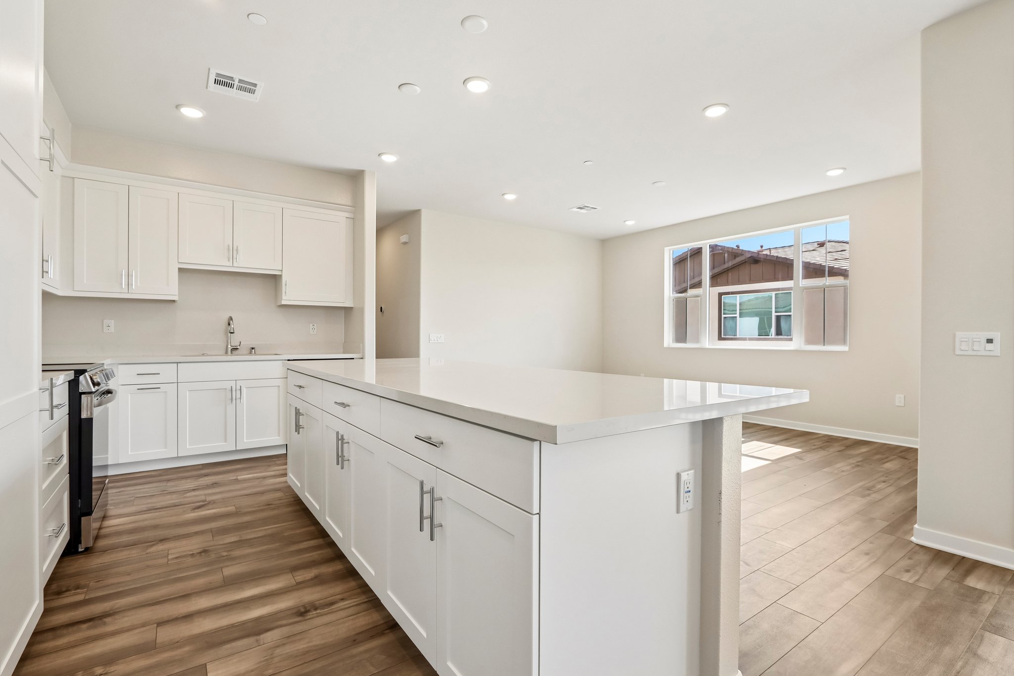 A kitchen with white cabinets.