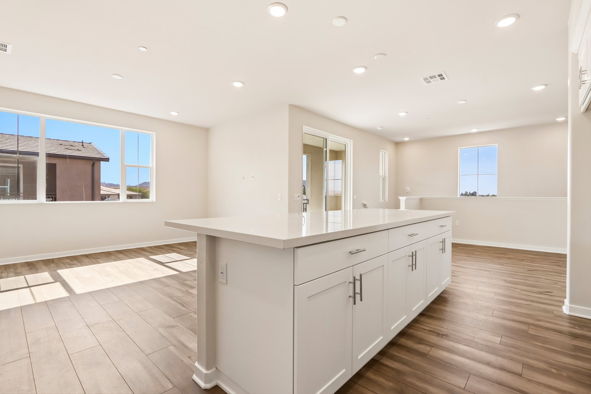 A large kitchen with white cabinets.