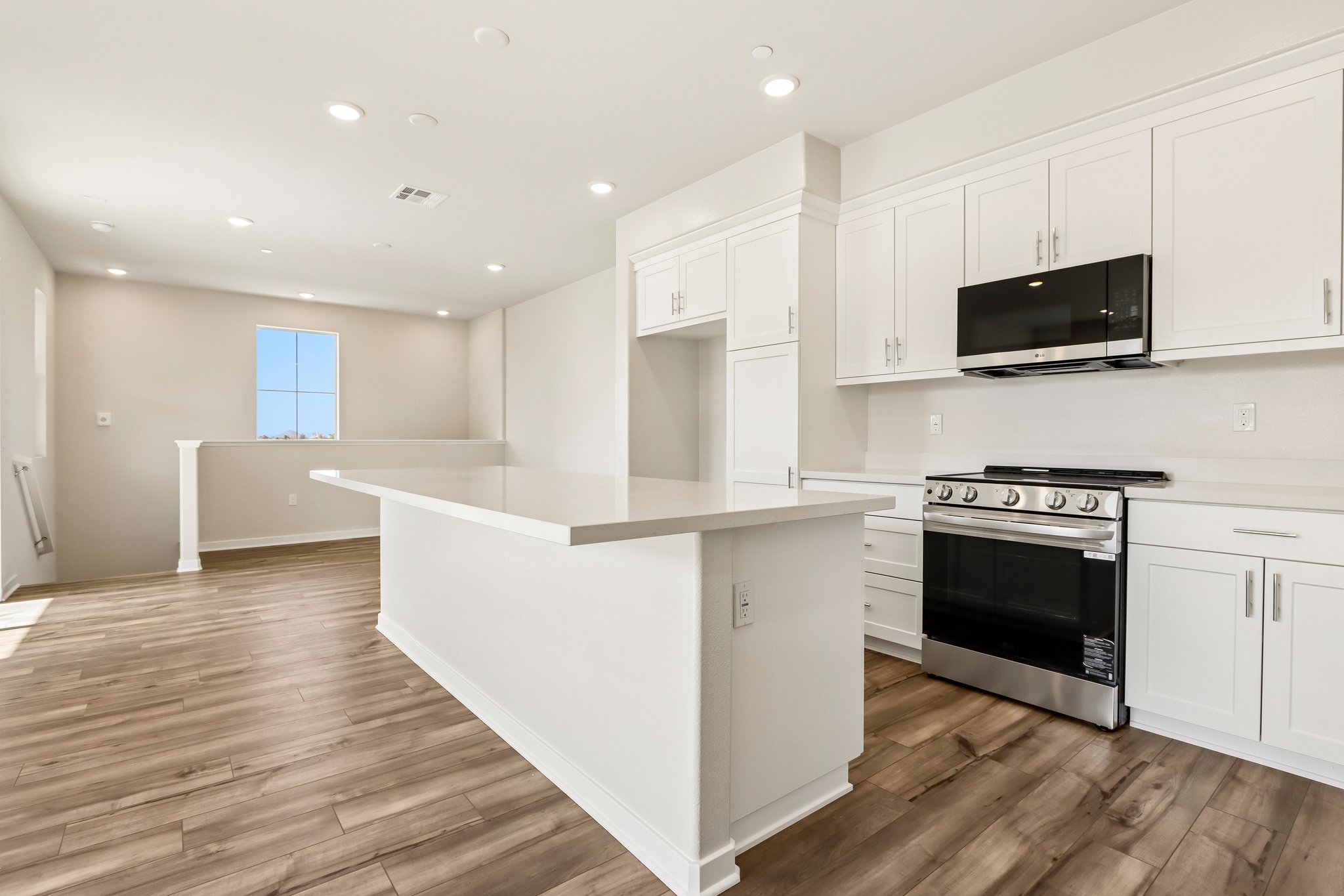 A kitchen with white cabinets.