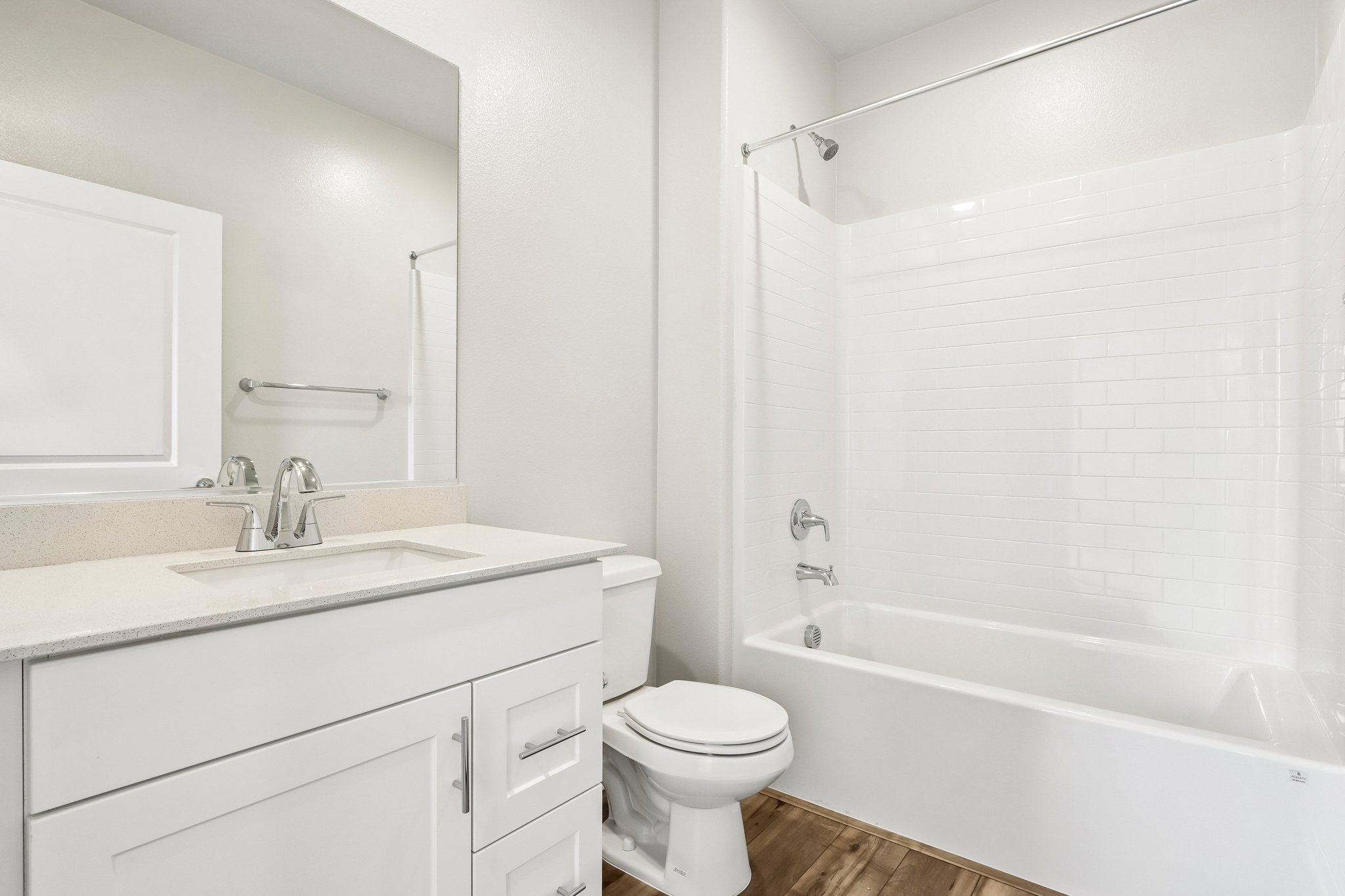 A bathroom with a tub toilet and sink.