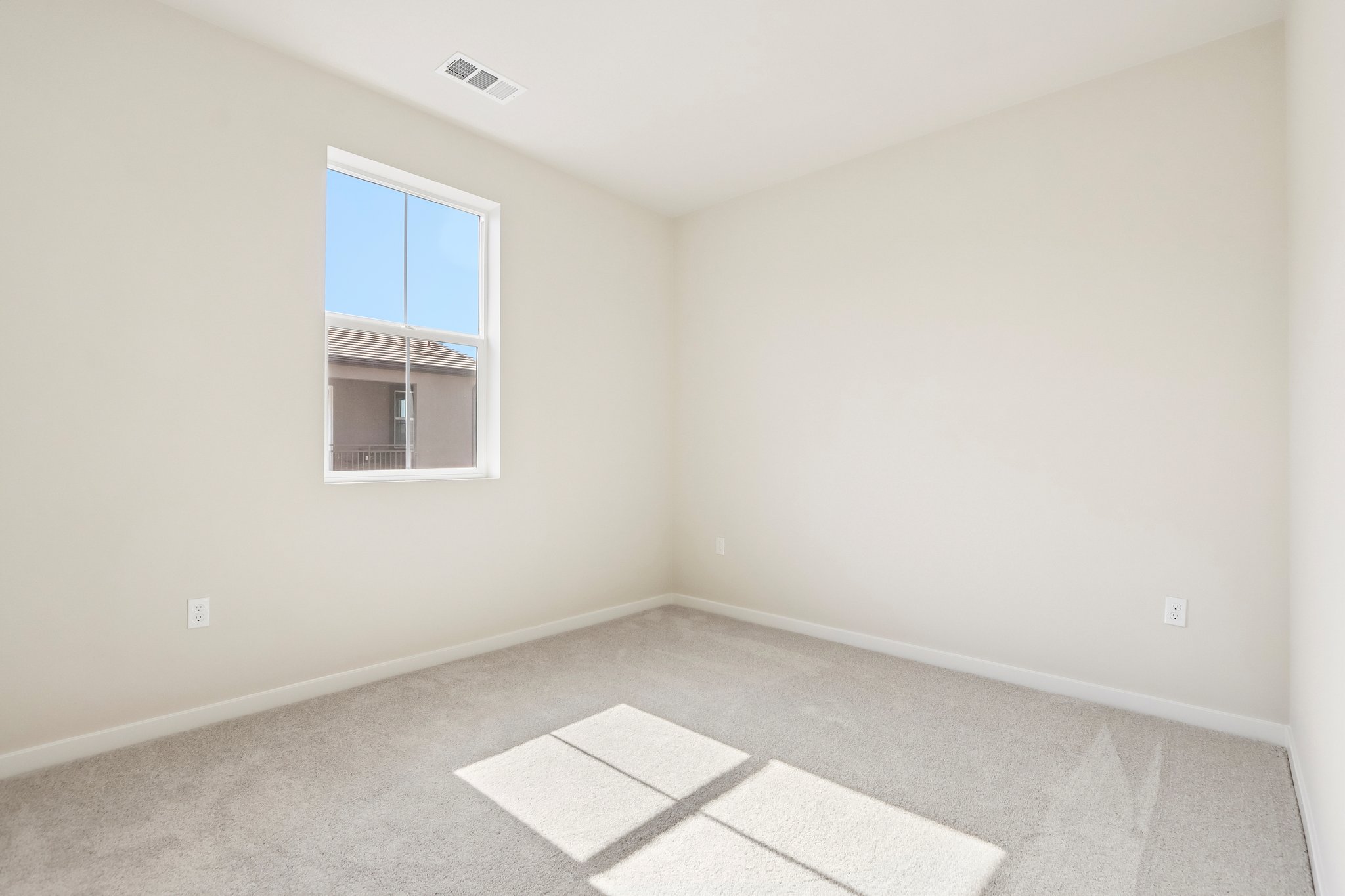 A room with a tile floor and a window.