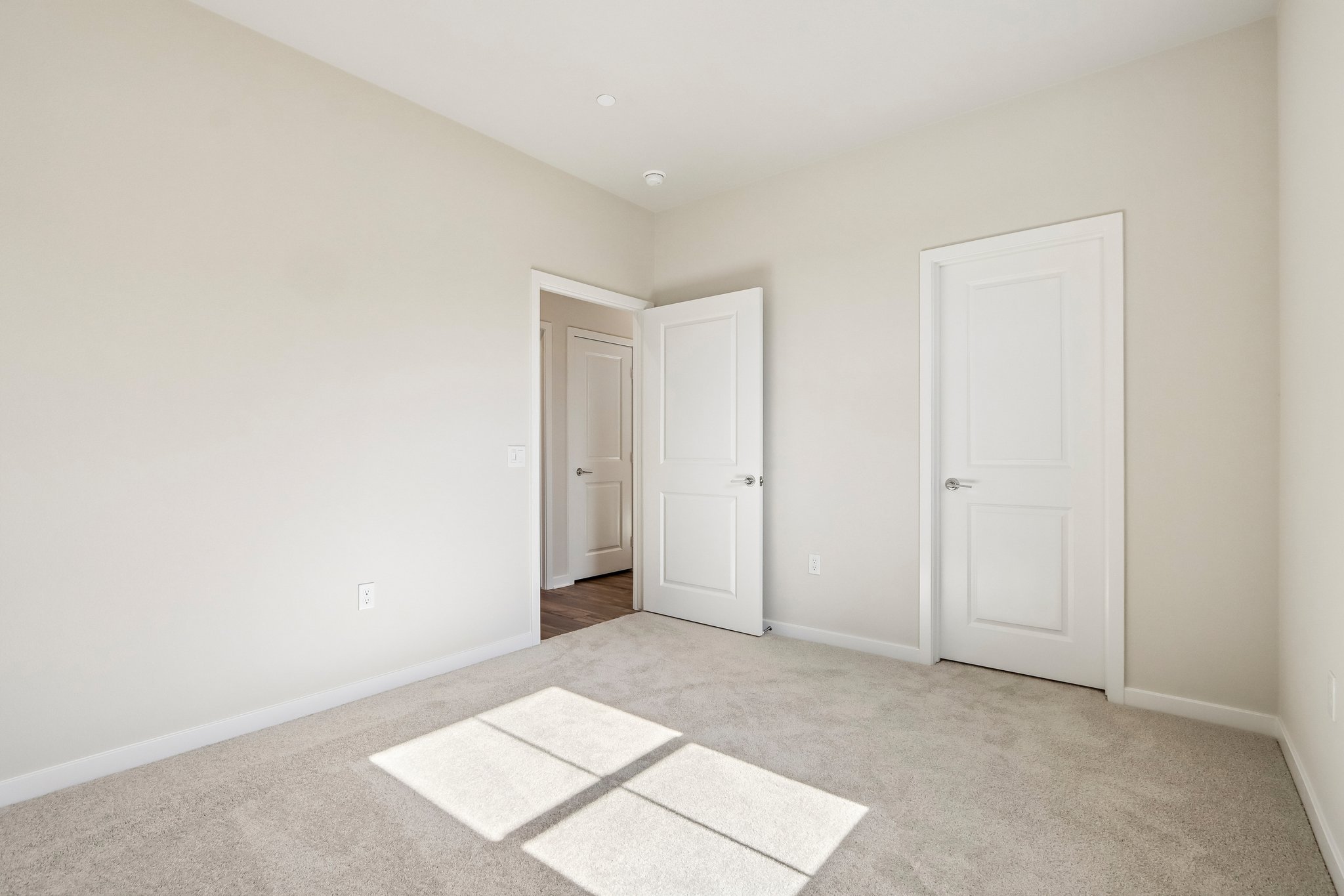 A hallway with white doors.