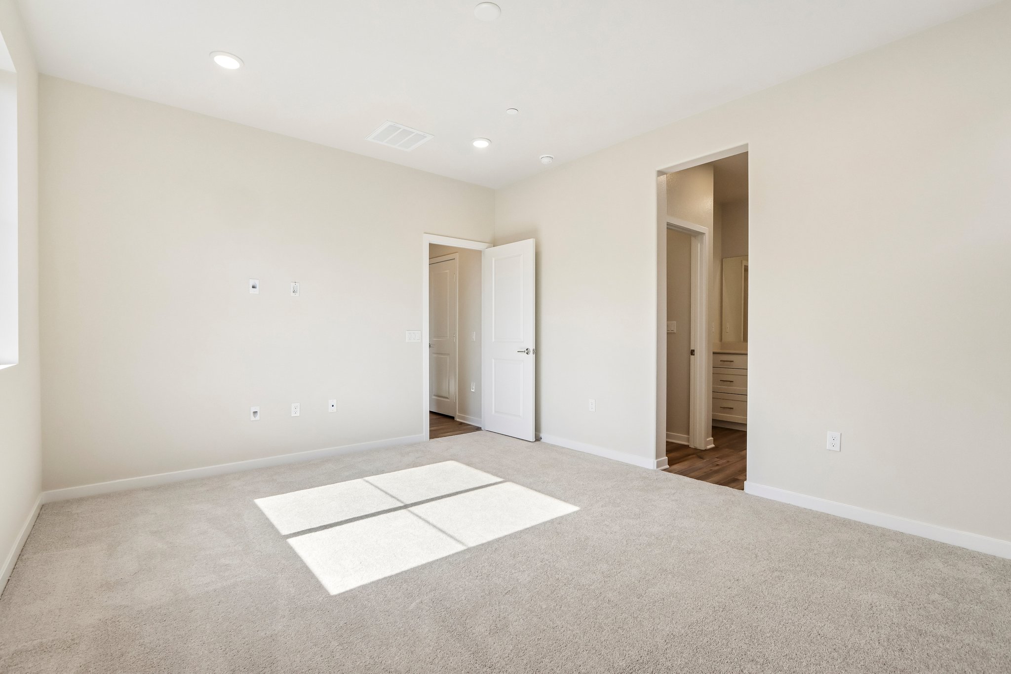 A hallway with white doors.