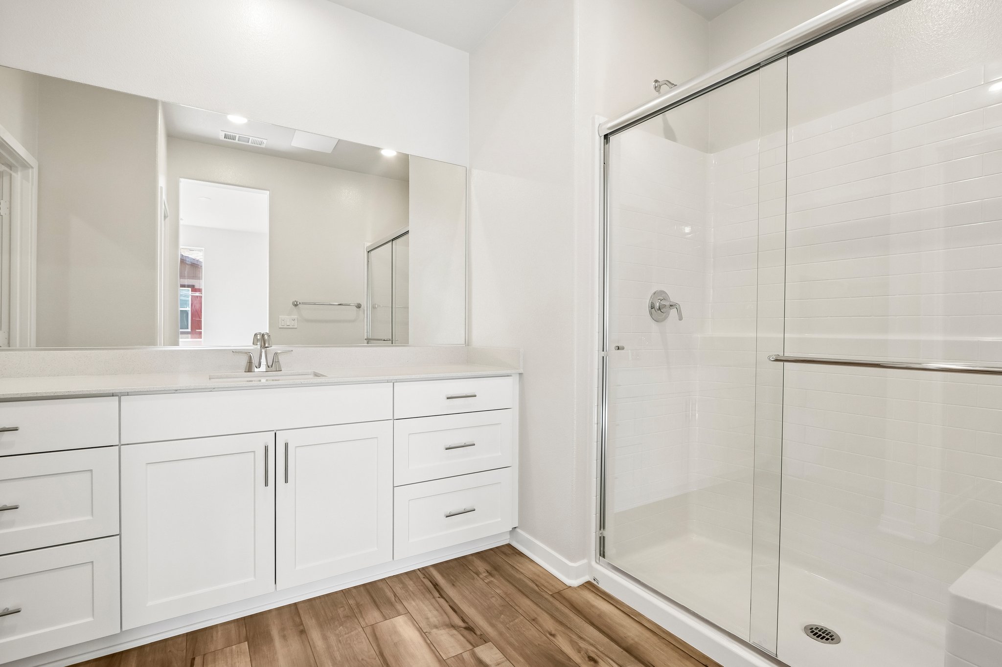 A bathroom with a glass shower.