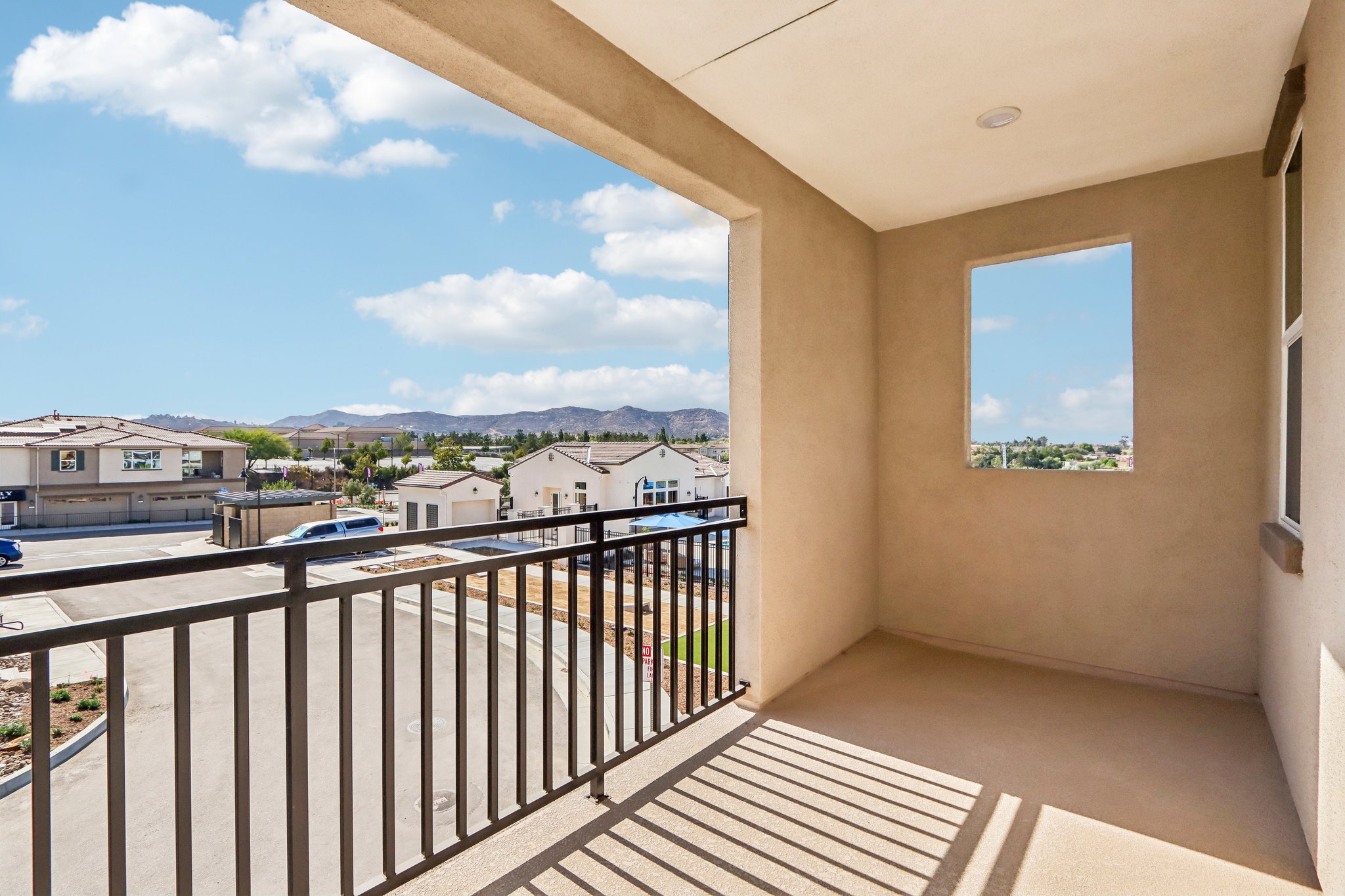 A balcony with a railing and a body of water in the background.